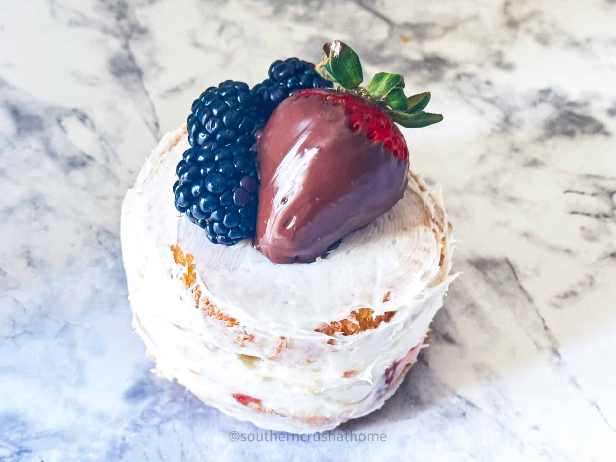 berries on top of mini layer cake
