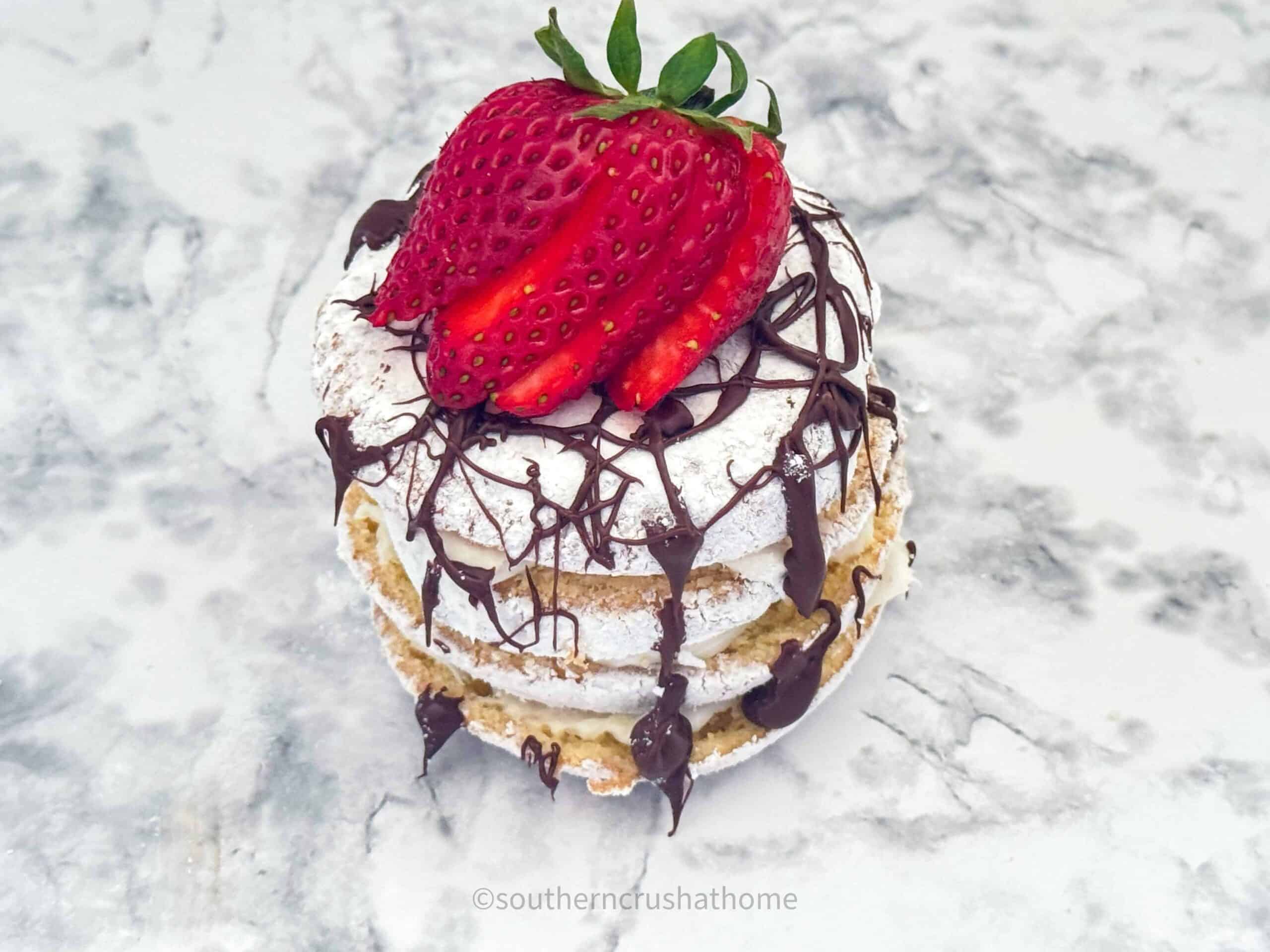 strawberry and drizzled chocolate on top of donut stack