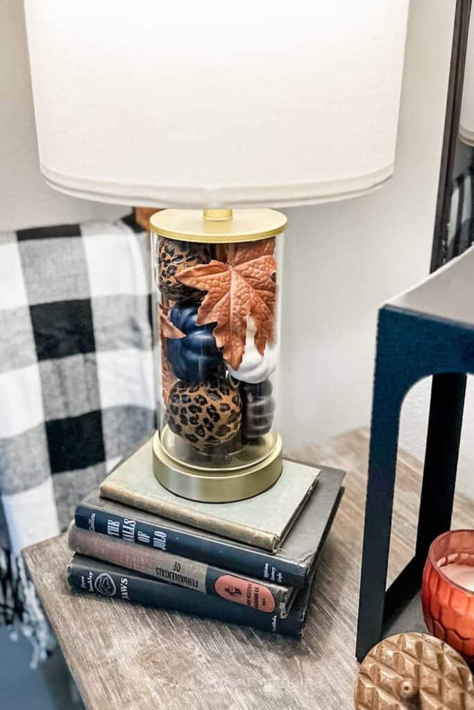 mini pumpkins in glass lamp