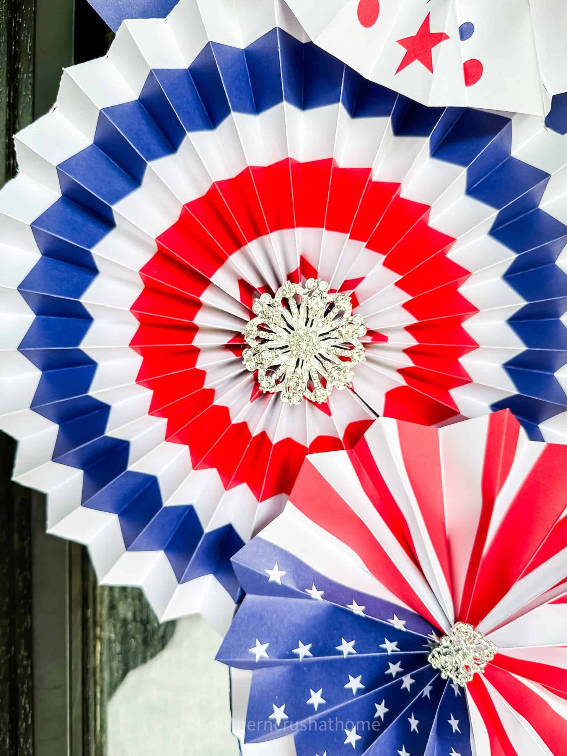 bling in the center of the red white and blue paper fan