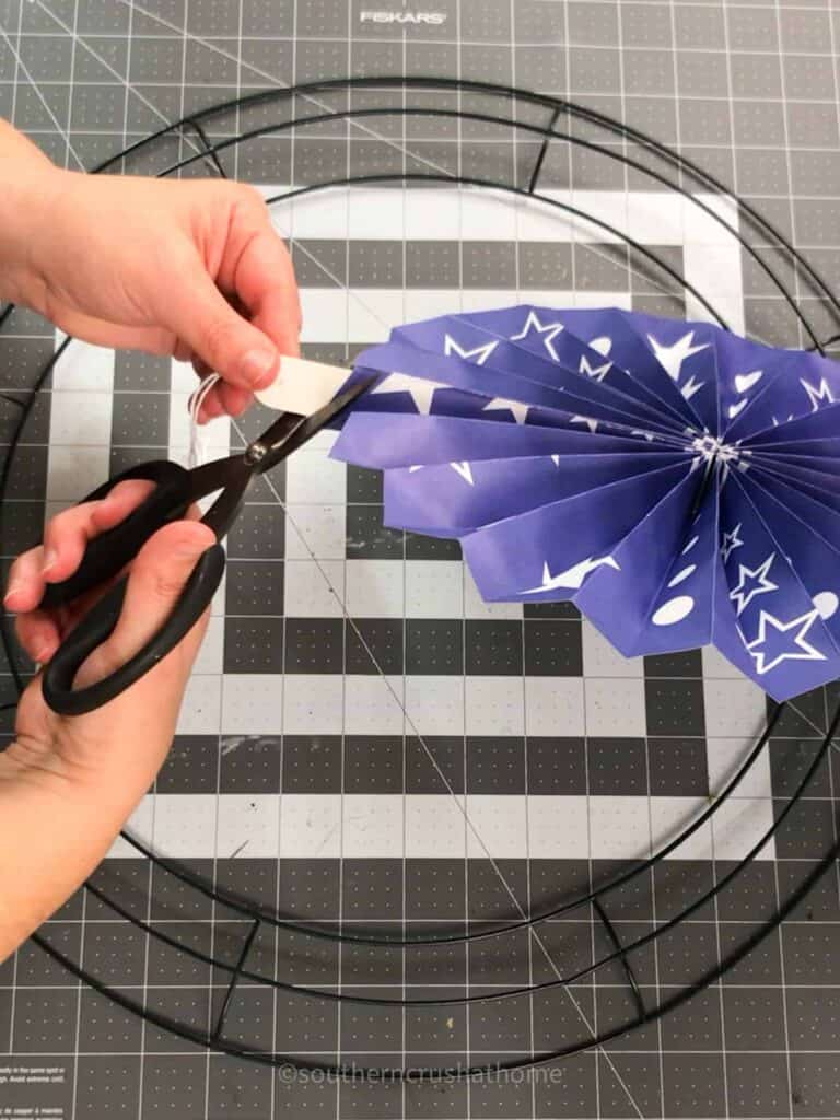 trimming excess handle and string from paper fan