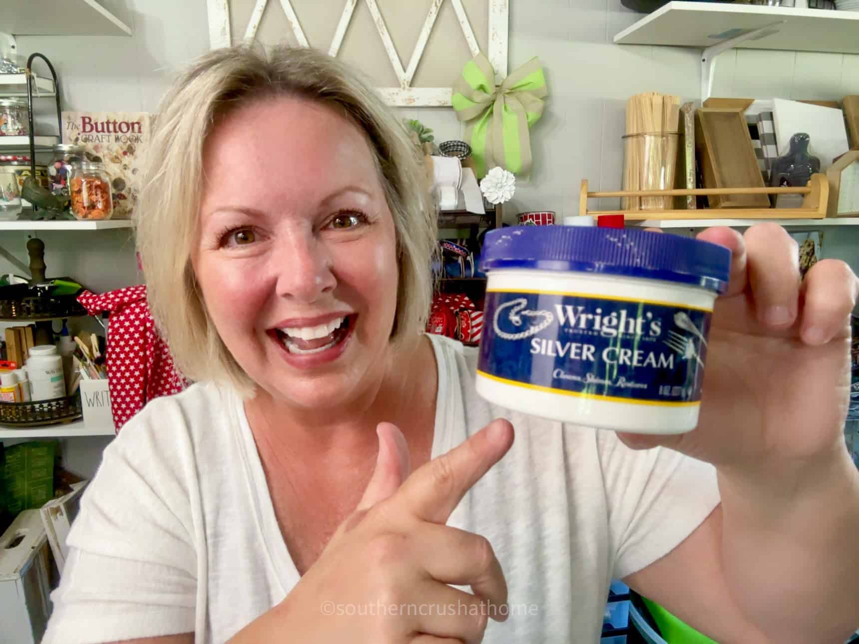 Melanie holding up a jar of Wright's silver polish