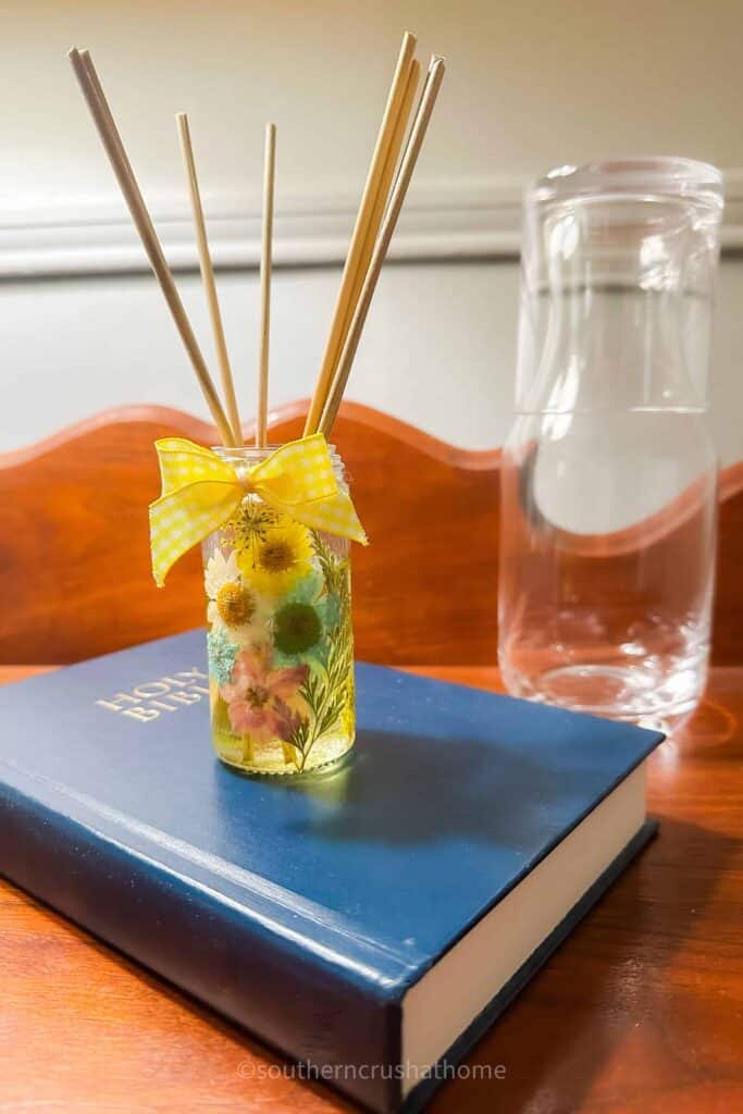 reed diffuer with dried flowers on nightstand