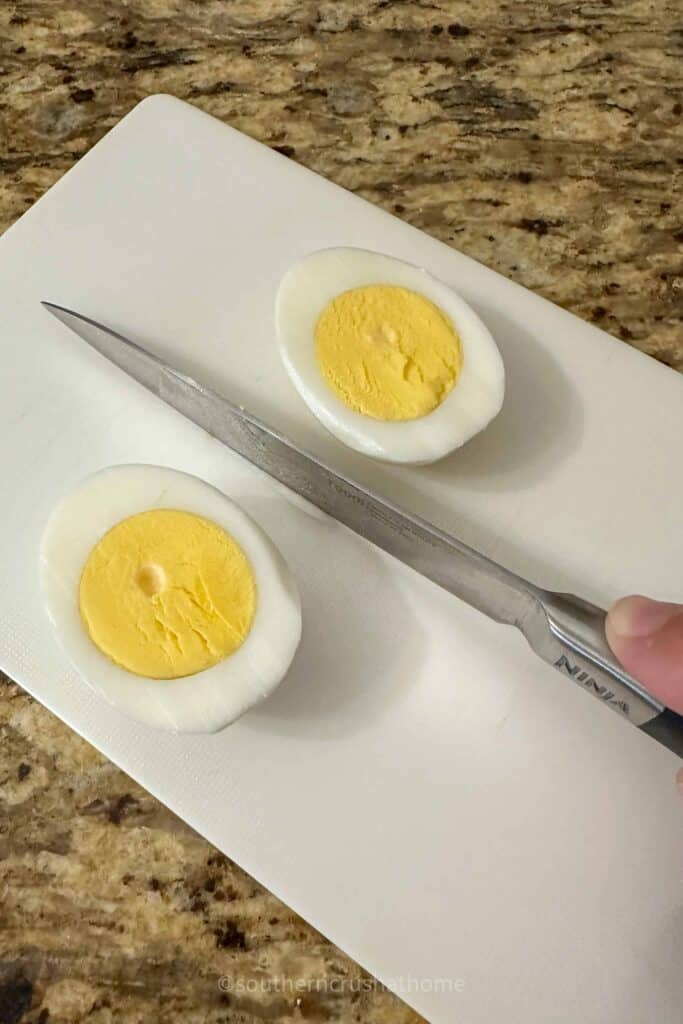 slicing boiled egg in half