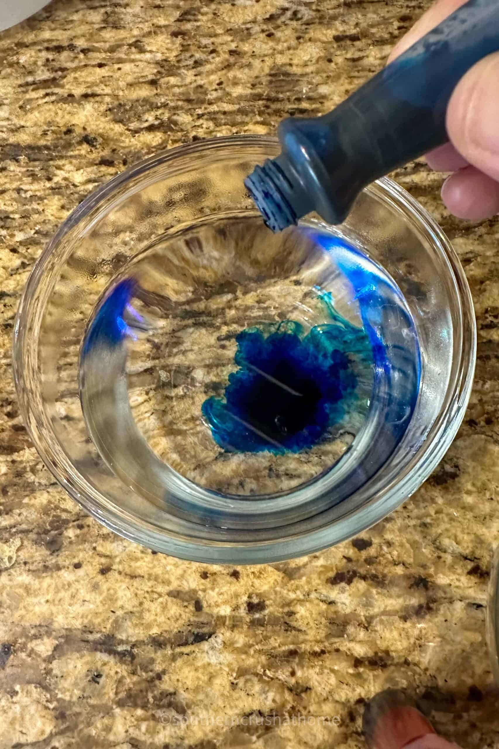 adding blue food coloring