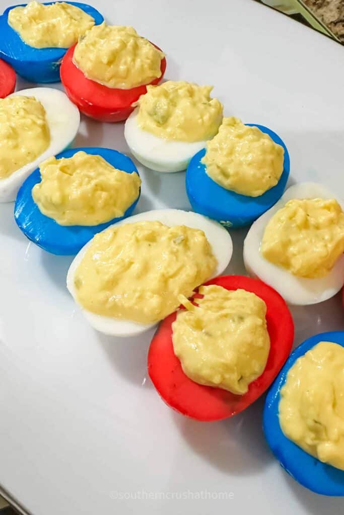 close up of red, white, and blue colored deviled eggs