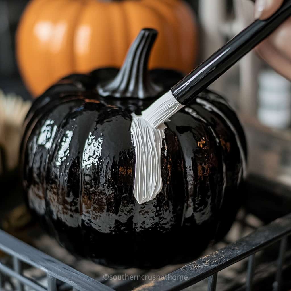 applying white paint to crackle pumpkin