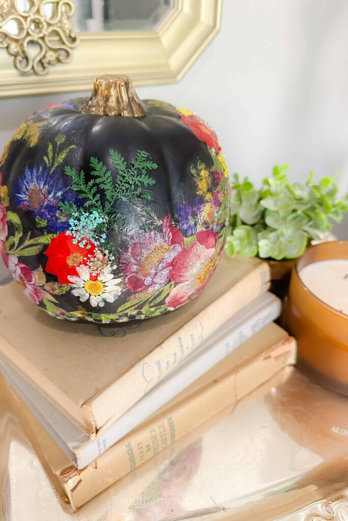 final decoupage pumpkin on book stack