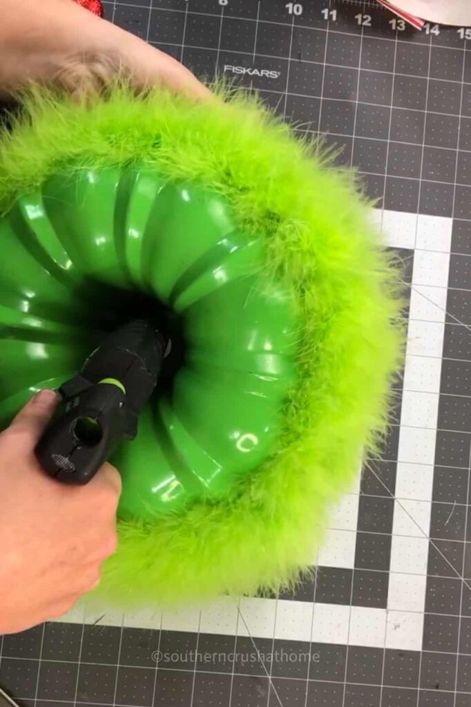 gluing the grinch heart in the center of the bundt pan