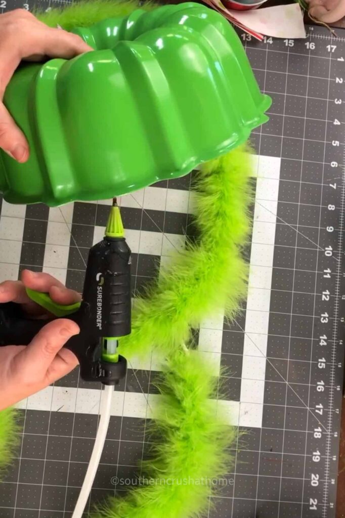 gluing the boa on the bundt pan