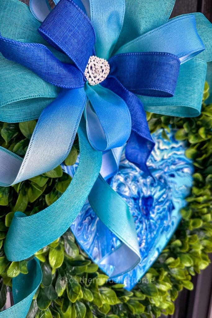 up close of bow on blue heart wreath