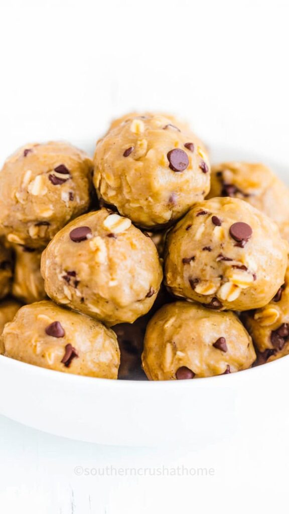 A plate of no-bake peanut butter oat balls with chocolate chips and flax seeds.