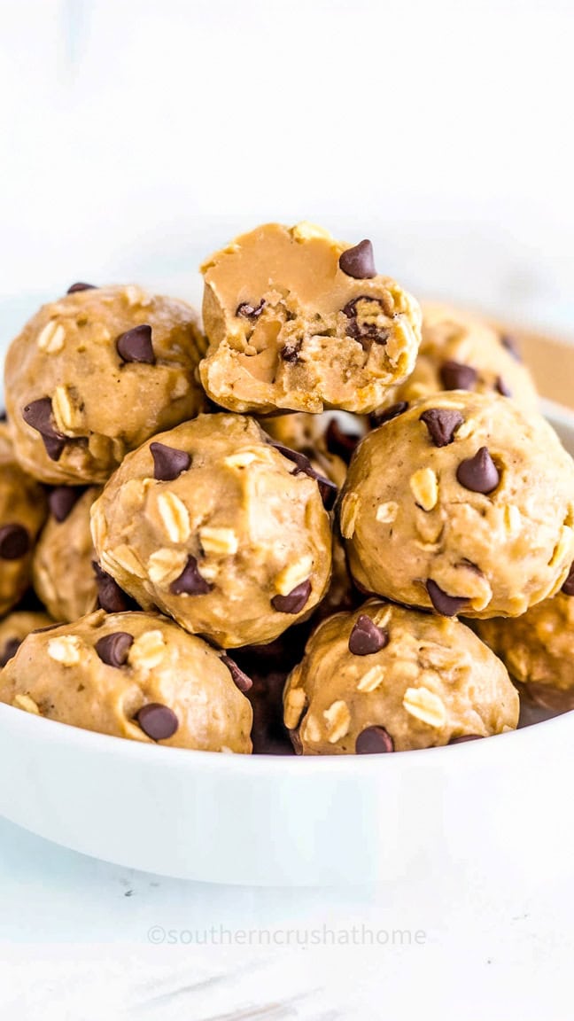 A plate of no-bake peanut butter oat balls with chocolate chips and flax seeds.