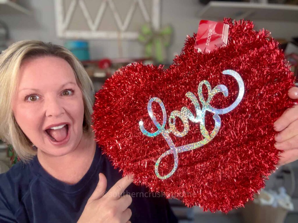 melanie holding heart decor from dollar tree