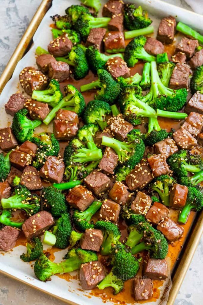 Delicious beef and broccoli dish served on a sheet pan with rice.