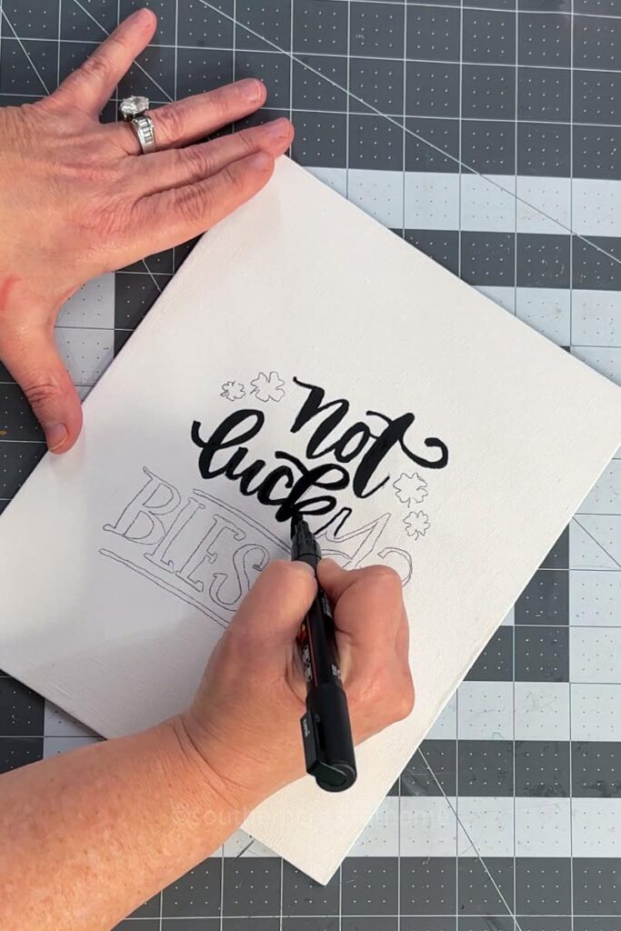 filling in the handlettering with a posca marker