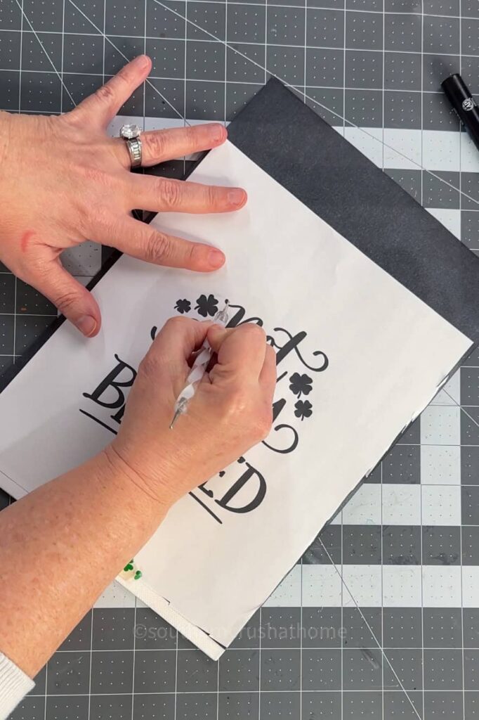 tracing the hand lettering template with embossing tool